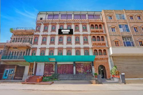 a building with a sign on the front of it at Palette Hotel and Resorts Jodhpur Airport Formerly Royale Plazo in Jodhpur