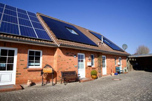 a house with solar panels on the roof at Hus Utspann in Nordstrand
