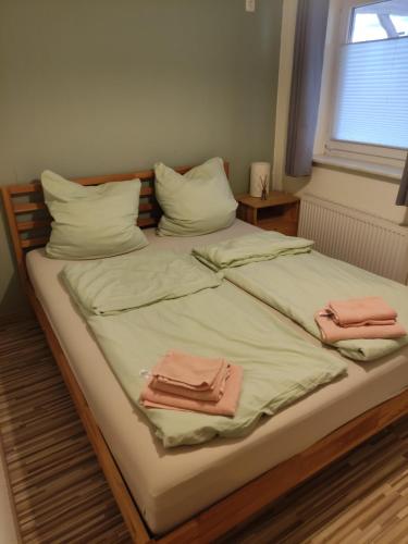 a large bed with two folded towels on it at Ferienwohnung am Rennsteig in Gerstungen