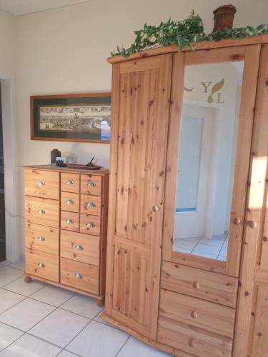 a large wooden cabinet next to a dresser at Ferienwohnung Irene in Bad Saulgau
