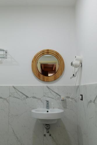 a bathroom with a sink and a mirror at Hotel Mille Amici in Shëngjin