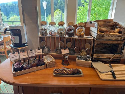 a table with many different types of food on it at Waldhaus am See in Willingen