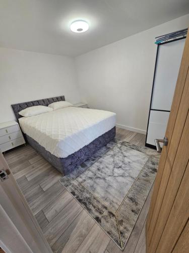 a bedroom with a bed and a mirror and a door at Bright luxurious Home in Oxford