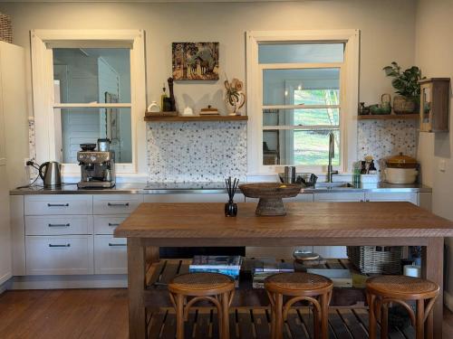 a kitchen with a large wooden table and chairs at Hoop Lodge in Bellingen