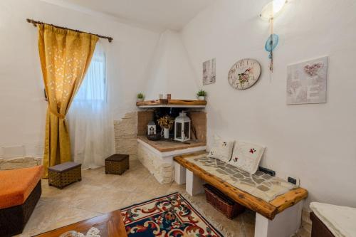 a living room with a bench and a table at Villa NiLo Natura - Rustic Mountain Charm in Telti