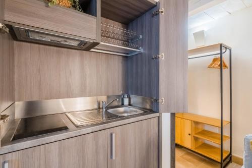 a kitchen with a sink and a refrigerator at Corte Dei Saraceni - Lecce Selection in Lecce