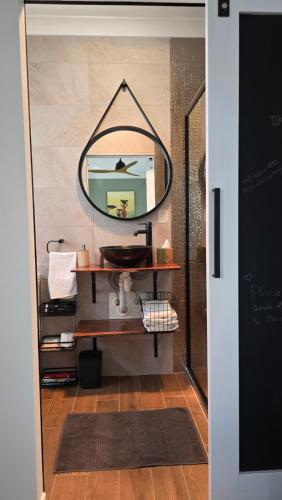 a bathroom with a sink and a mirror at Sunshine cottage in Clontarf