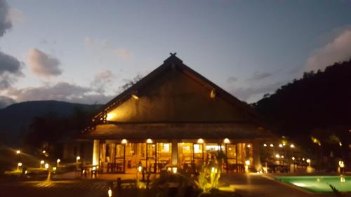 a building with lights in front of it at night at Namkat Yorla Pa Resort in Ban Kat
