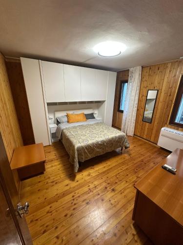 a bedroom with a bed and a wooden floor at Casa Alba in Chioggia