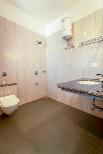 a bathroom with a toilet and a sink at Calangute Residency in Calangute