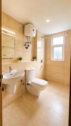 a bathroom with a toilet and a sink at Hidden house stay in Mathura