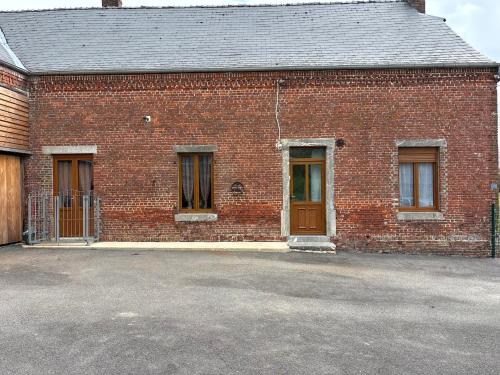 a brick building with a door and two windows at Country house in Erloy, Oise valley in Erloy