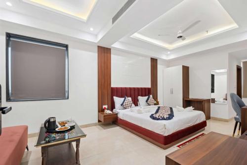 a bedroom with a bed and a living room at Hotel The Balram in Ayodhya