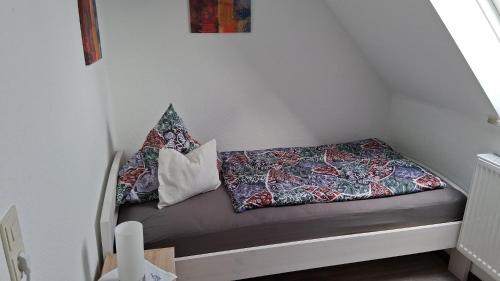 a small bench with pillows on it in a room at Ferienwohnung Mariechen in Medebach