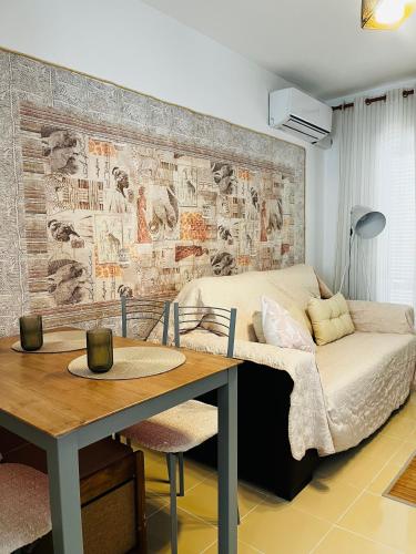 a room with a bed and a table and a couch at Apartamento de las Buganvillas in Vera