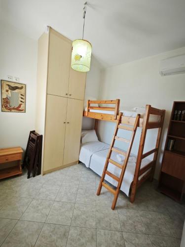 a room with two bunk beds and a cabinet at SeaSummerSand Apartment in Chios
