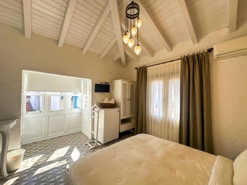 a bedroom with a bed and a refrigerator at Filizce Alaçatı in İzmir