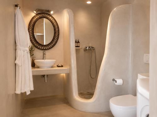 a bathroom with a shower and a sink and a toilet at Aenia Suites in Foinikiá