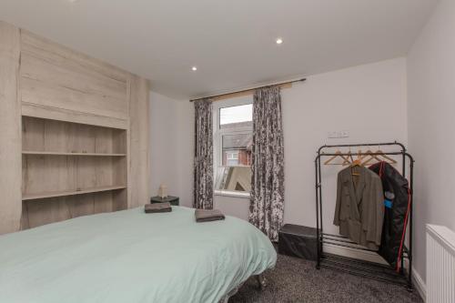 a bedroom with a bed and a window at High End Central Location 2 Bedroom in Stoke on Trent