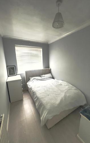 a bedroom with a white bed and a window at The Stanford Home in Horndon on the Hill