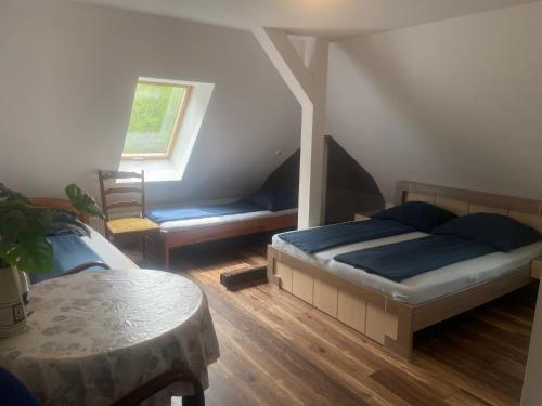 a bedroom with a bed and a couch and a window at Baltic Home in Polanica-Zdrój