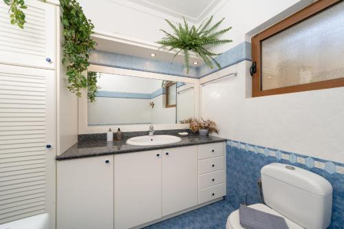 a bathroom with a sink and a toilet at Theros Maisonette by A&D Properties in Porto Rafti