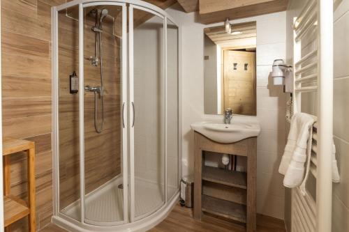 a bathroom with a shower and a sink at Residence Le Roc Noir by Alpapart in La Rosière