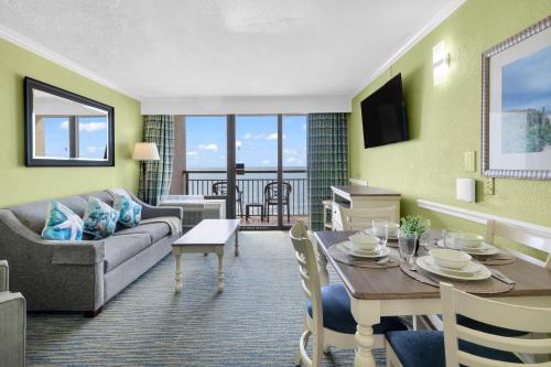 a living room with a couch and a table at Condos at the Caribbean Resort in Myrtle Beach