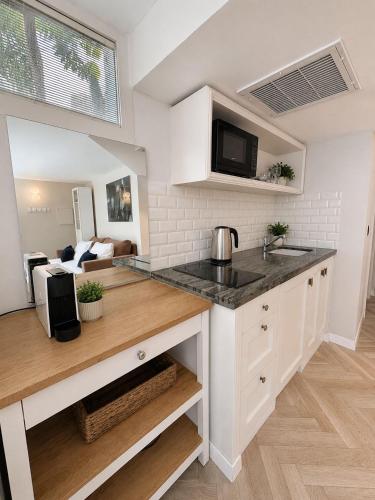 a kitchen with a counter with a sink and a microwave at Noa's Place in Eilat