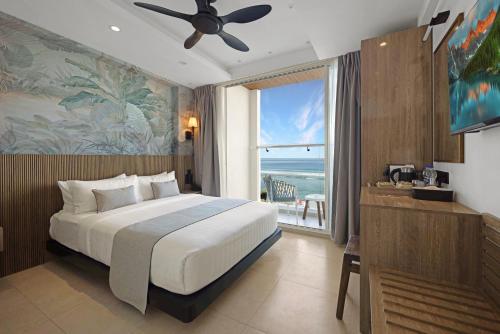 a bedroom with a bed and a view of the ocean at Hotel Amber Seaside in Hulhumale