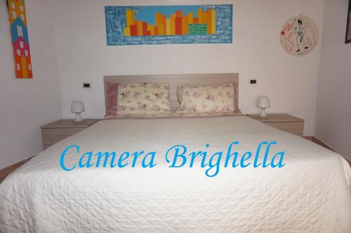 a bedroom with a bed with a comforter on it at Bergamum F.L. in Bergamo