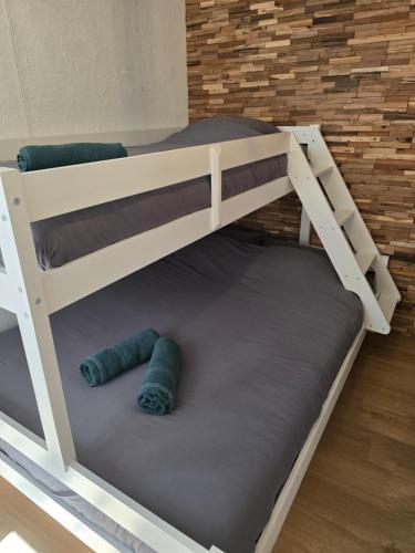 a bunk bed with two blue rugs on the bottom bunk at Appartement cosy 2 chambres in Wenduine