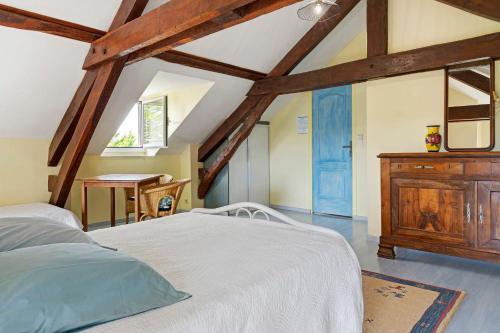 a bedroom with a white bed and a wooden dresser at Chambres D'hotes Vignolo in Pontiacq-Viellepinte