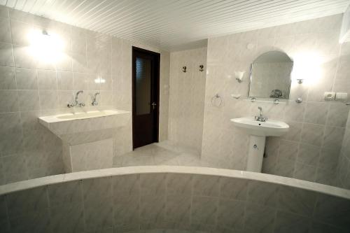 a bathroom with a sink and a bath tub and a sink at Apartment Gardenia in Kutaisi