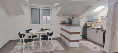a kitchen with a table and chairs in a room at Sofija's Home in Negotino