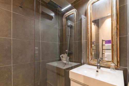 a bathroom with a sink and a mirror at Le Studio - Ancienne Cave in Patrimonio