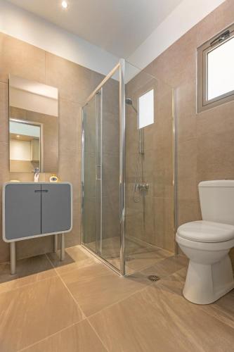 a bathroom with a shower and a toilet and a sink at Vergina Sun in Faliraki
