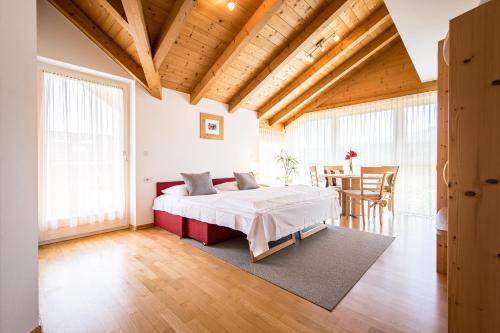 a bedroom with a bed and a dining room at Residence Walder in Falzes