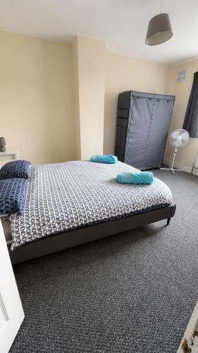 a bedroom with a bed with two pillows on it at Cosy 3 Bed house with garden 5 min walk from Doncaster Racecourse in Doncaster