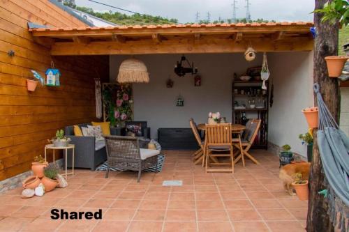 a patio with chairs and a table in a house at Casa Nunes 2 in Pinhão