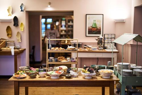 a table with many bowls of food on it at freustil Hotel in Binz