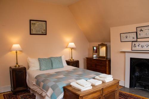 a bedroom with a bed with towels on it at Benslow Music Historic Stay in Hitchin in Hitchin