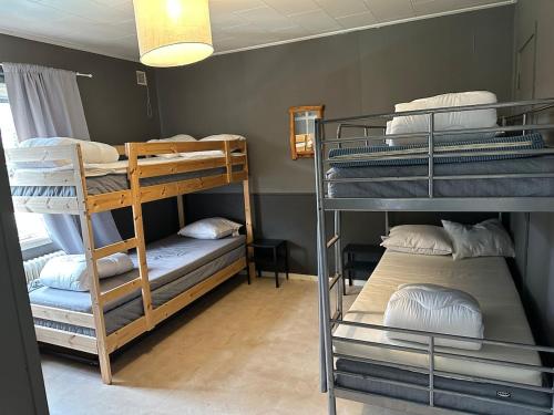 a room with three bunk beds in a room at Stor villa med jacuzzi in Herräng