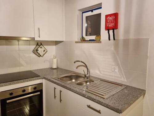 a kitchen with a sink and a counter top at Casa da Eira in Arganil