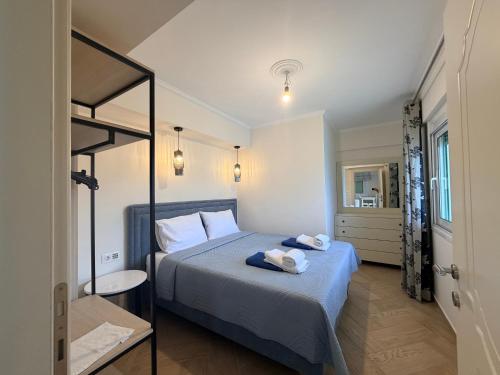 a bedroom with a bed with two towels on it at Villa Aleandro in Ksamil