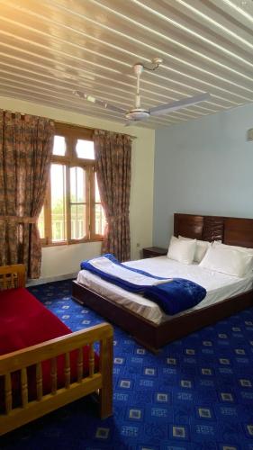 a bedroom with a large bed and a window at Comfort Inn in Chitral