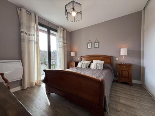 a bedroom with a bed and a large window at Iduzki-alde bi in Souraïde