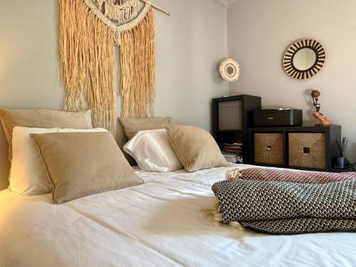 a bed with white sheets and pillows in a room at Casa do Castelo by CORAL in Silves
