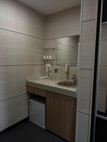 a bathroom with a sink and a mirror at Отель Бестау in Aksay