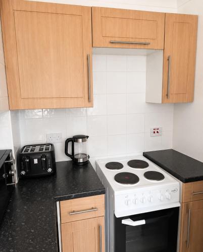 a kitchen with a stove and a counter top at 2BR Mariners Stay - Newhaven in Newhaven